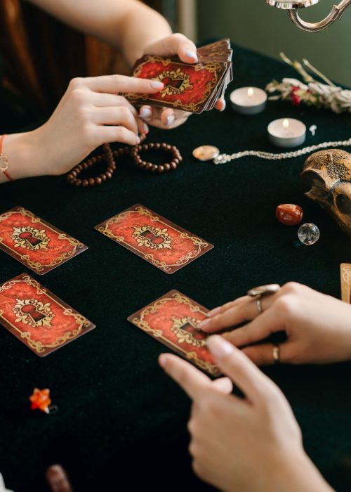 A tarot card reading session with crystals and candles, creating a mystical atmosphere.